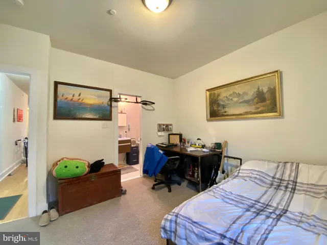 a bedroom with bed and a desk