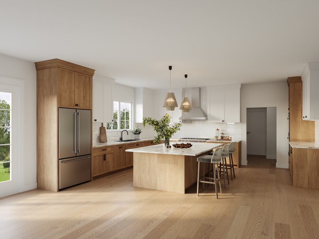 8 Warren Road Natick, MA 01760 - Photo 3 of 7 a kitchen with stainless steel appliances a stove a refrigerator a sink a dining table and chairs