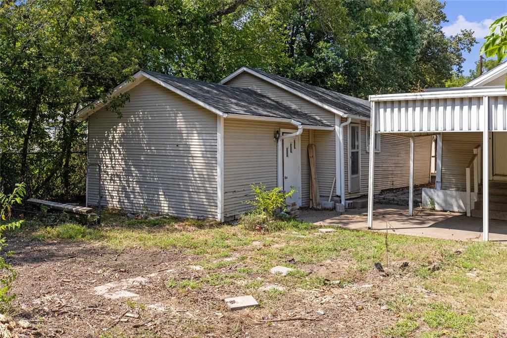 1005 Jernigan Street Commerce, TX 75428 - Photo 38 of 40 Two large storage/workshop spaces off the rear of the carport!