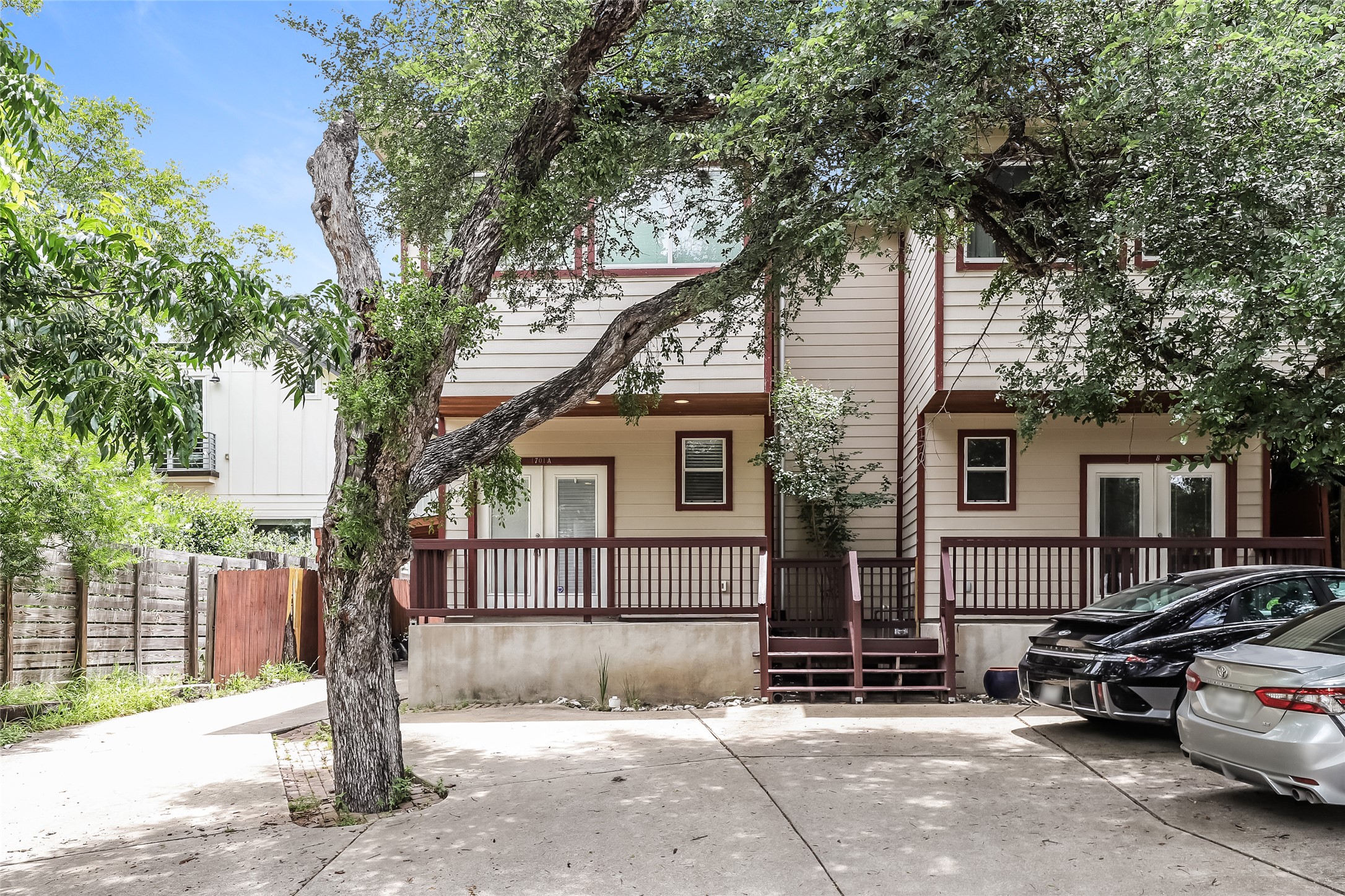 A well-maintained facade with rich wood accents and a convenient parking area.