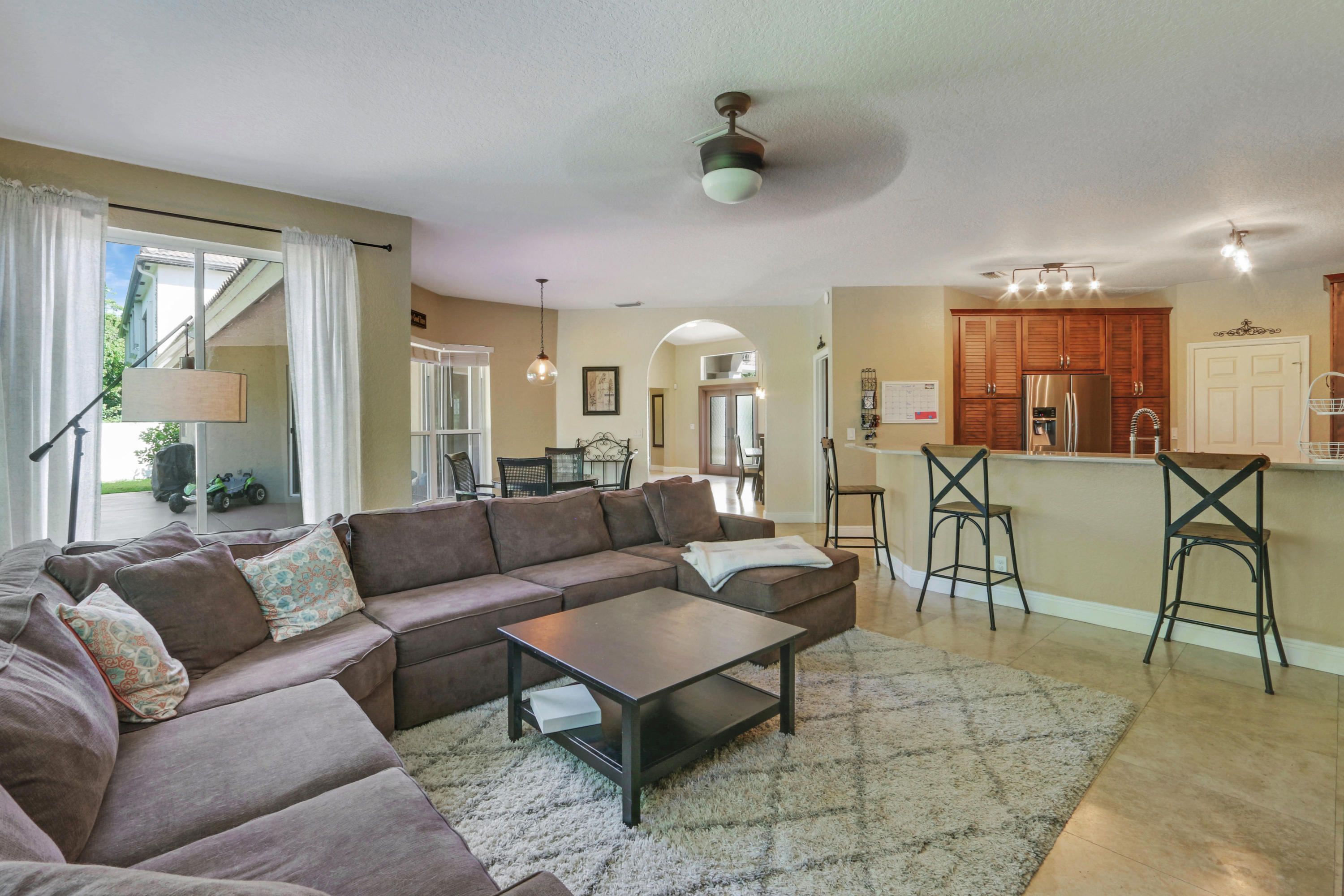 10951 Ravel Court Boca Raton, FL 33498 - Photo 12 of 26 a living room with furniture and a large window