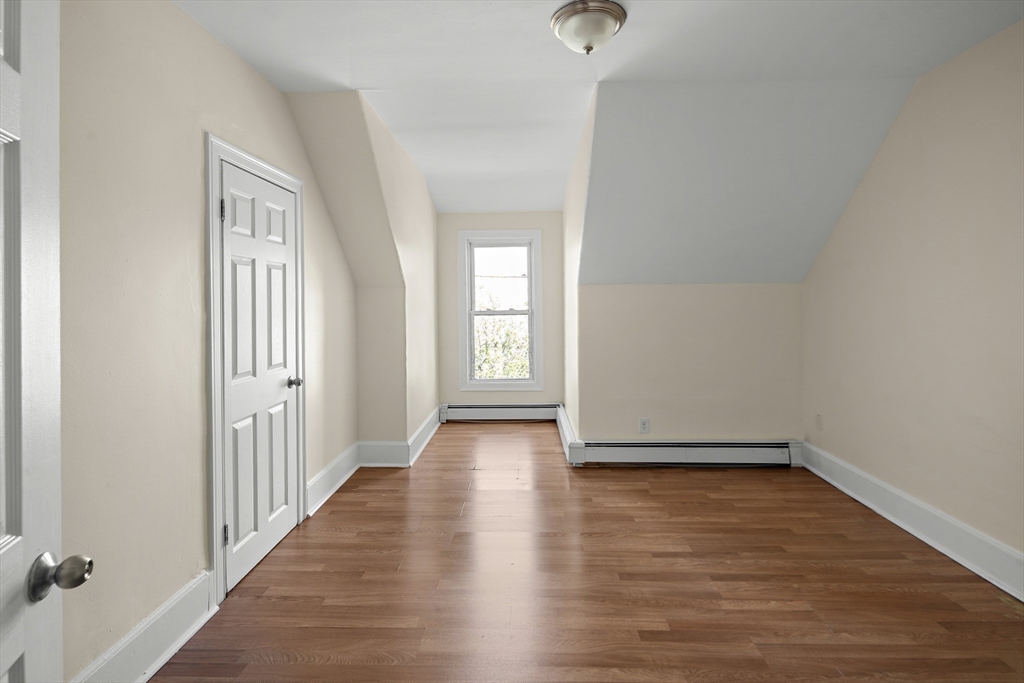 37 Union Street, Unit 2 Everett, MA 02149 - Photo 11 of 15 a view of an empty room with wooden floor and a window