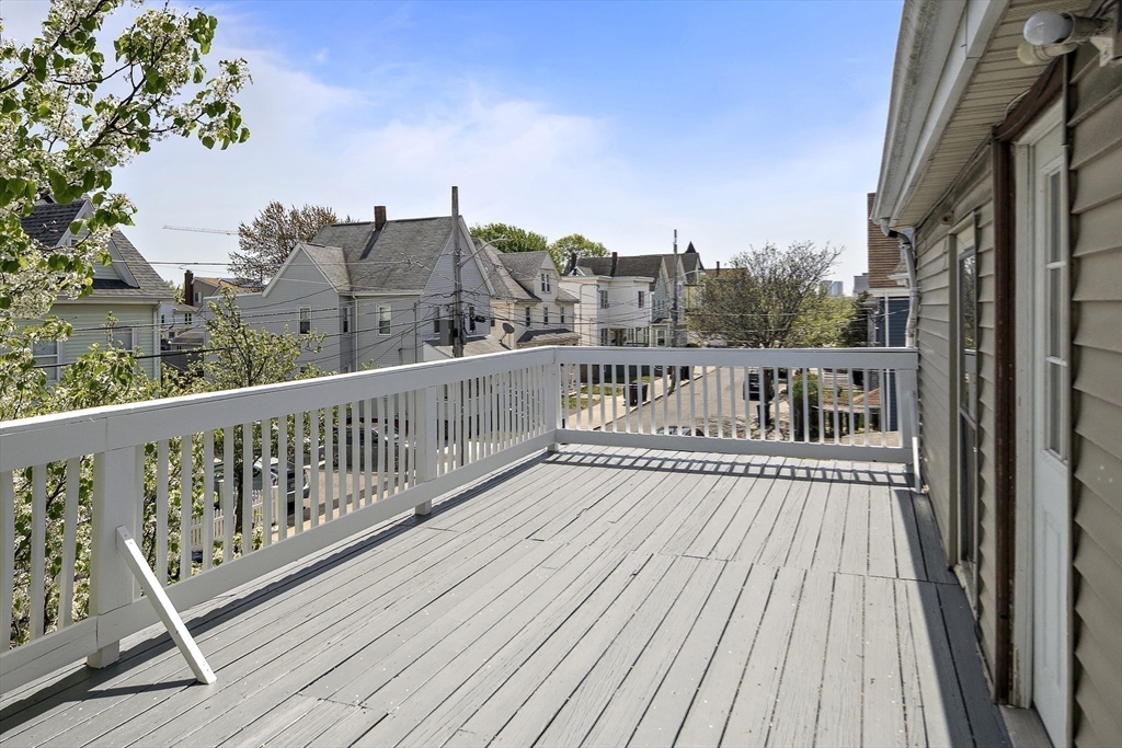 37 Union Street, Unit 2 Everett, MA 02149 - Photo 14 of 15 a view of a balcony with wooden floor and fence
