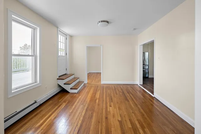 a view of wooden floor and windows in a room