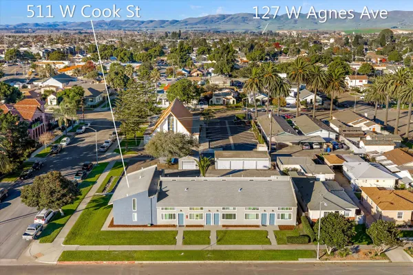 an aerial view of a residential apartment building with a yard