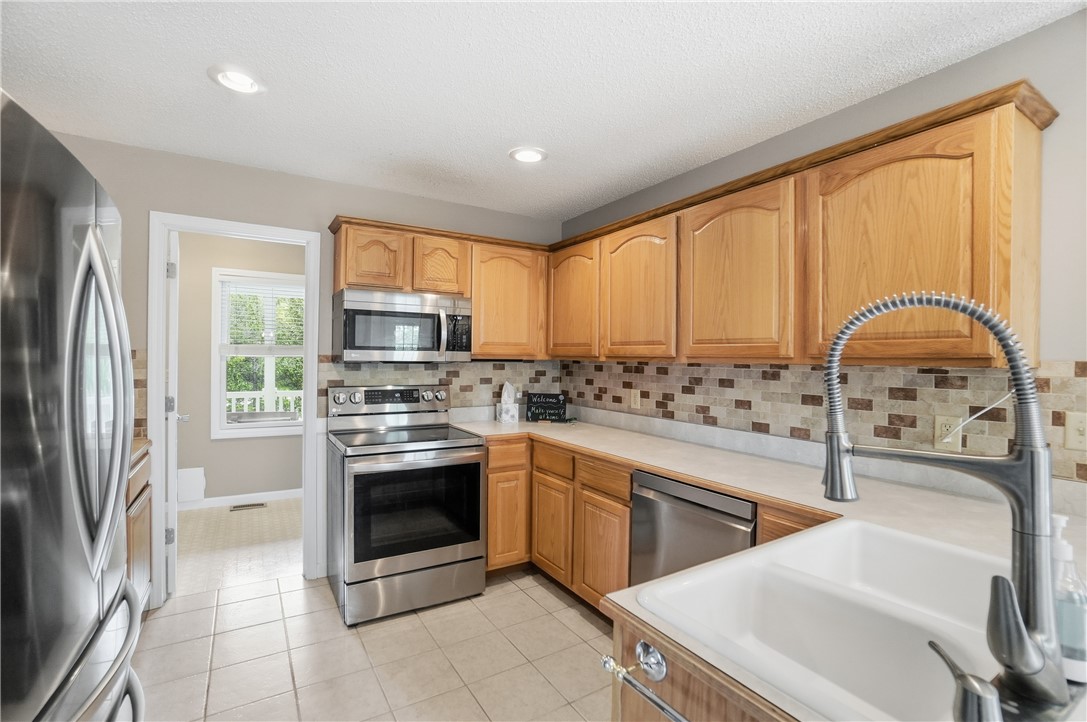 1208 Jarva Lane Springboro, OH 45066 - Photo 23 of 75 This bright kitchen offers modern appliances and abundant cabinetry, providing a functional and inviting culinary space.