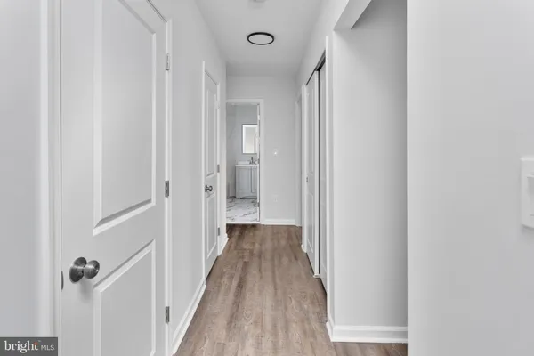a view of a hallway with wooden floor