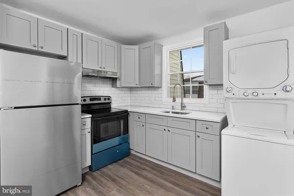a kitchen with white cabinets and white appliances