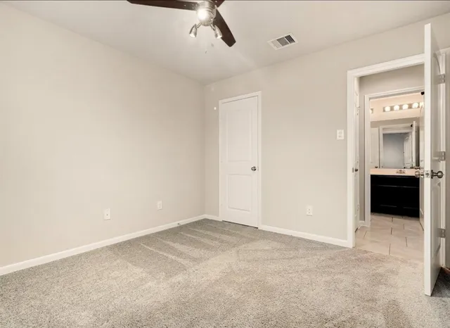 a view of a room with a ceiling fan