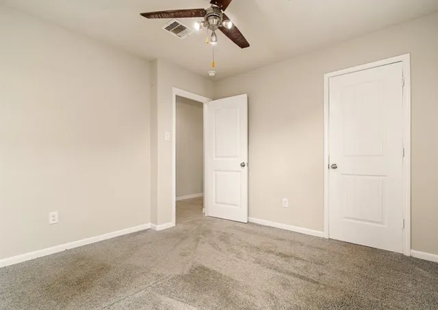 an empty room with a empty space and a ceiling fan