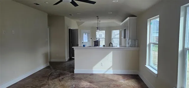 a kitchen with sink a microwave and refrigerator