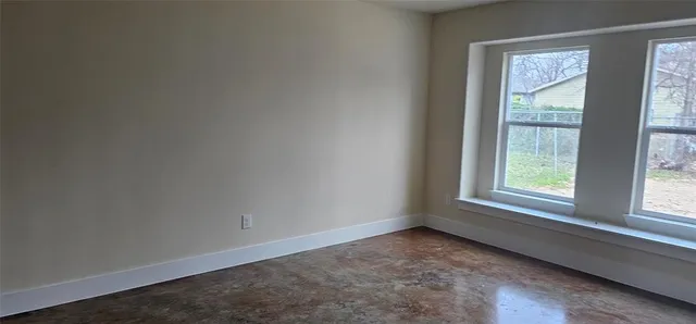 a view of an empty room and a window