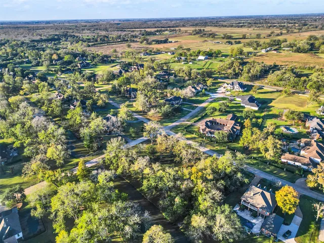 an aerial view of a house with swimming pool and outdoor seating