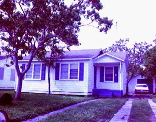 a view of a house with a tree front of it