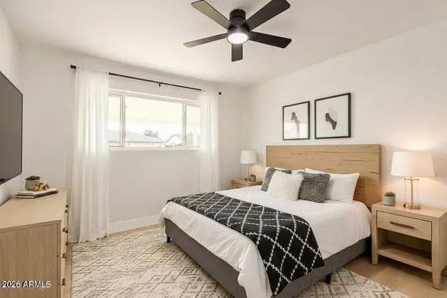 a bedroom with a bed and a window