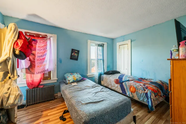 a bedroom with two beds and a window