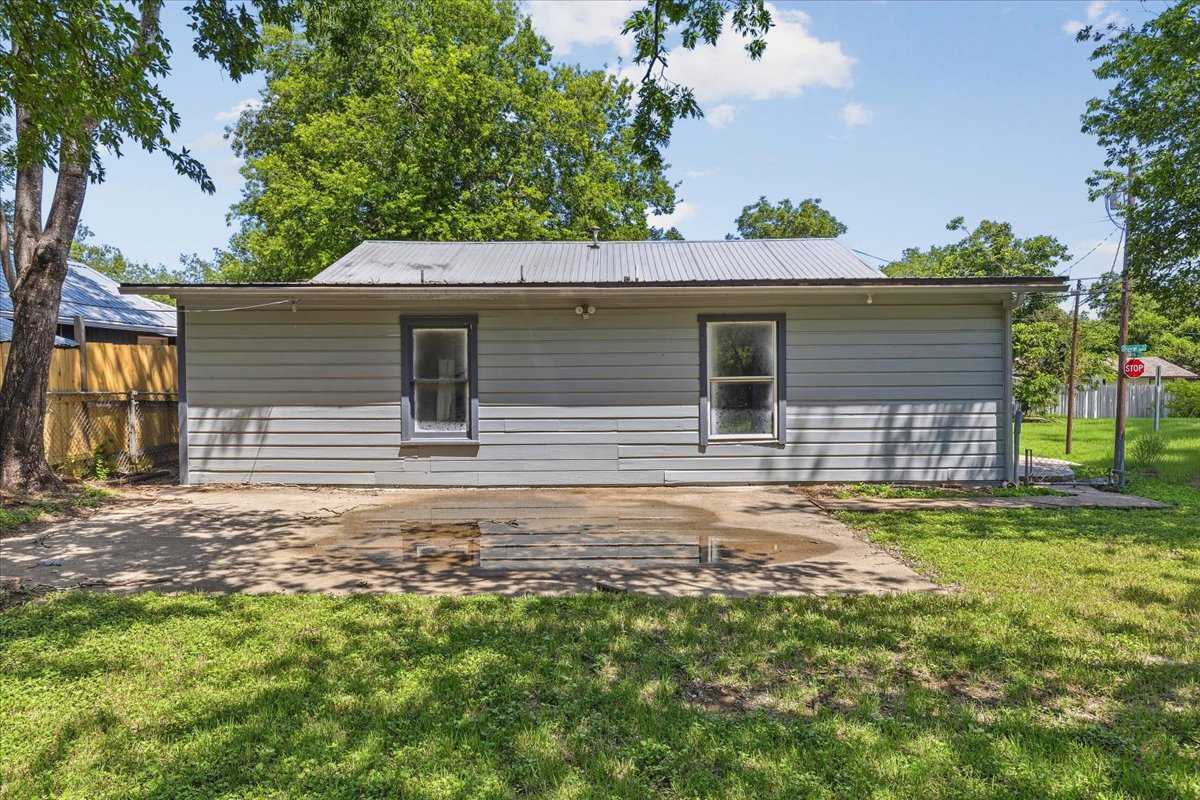 4900 Duval Street Austin, TX 78751 - Photo 25 of 25 Rear view of the home with shared utility/laundry access area on left side between the main house and attached rear apartment/flex space. The existing configuration offers flexibility for future renovation, reworking the floor plan, or exploring alternate use options.