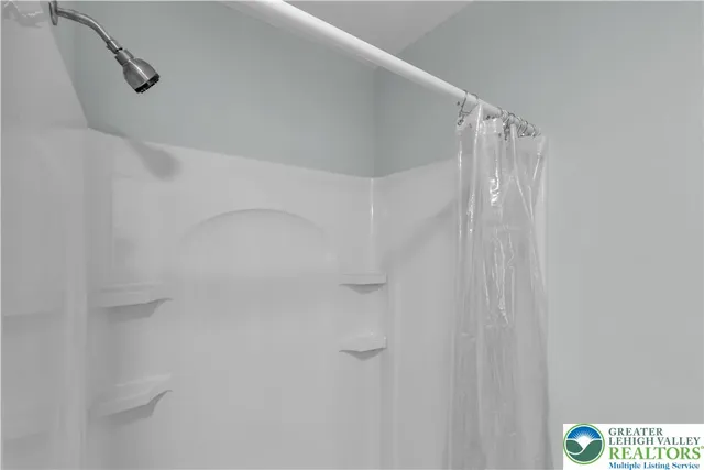 a bathroom with a sink a light fixture and a mirror