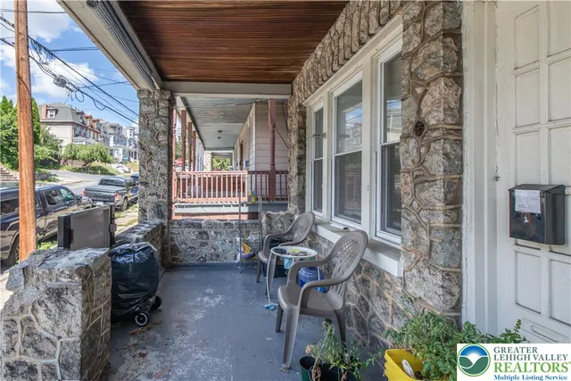 a view of balcony with two chairs and a potted plant