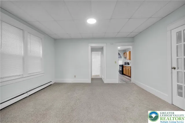 a view of an empty room and a window