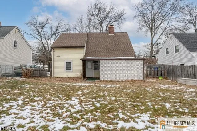 a view of a house with a yard covered in snow