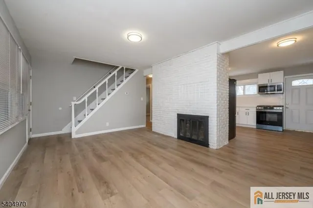 a view of a livingroom with an empty space and a fireplace