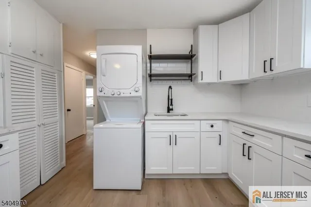 a kitchen with white cabinets and white appliances