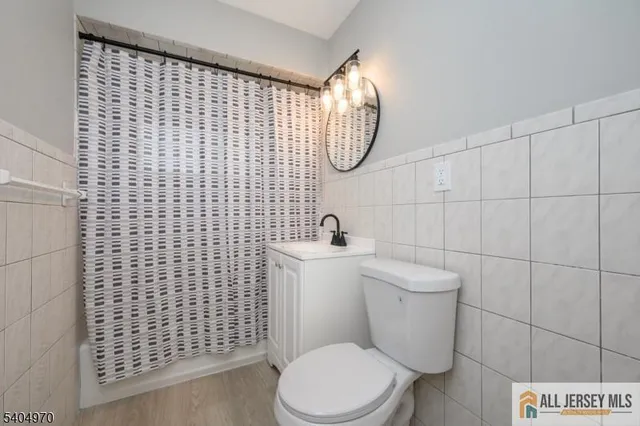 a white toilet sitting next to a bathroom sink