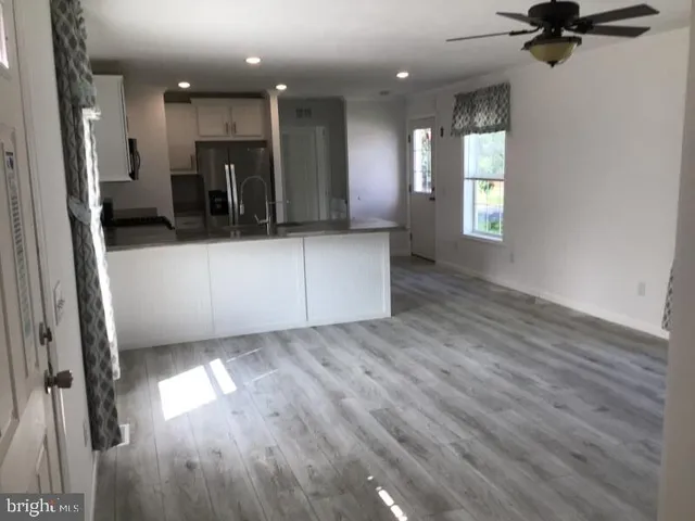 wooden floor in kitchen and a sink in a room