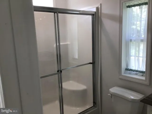 a bathroom with a glass shower door