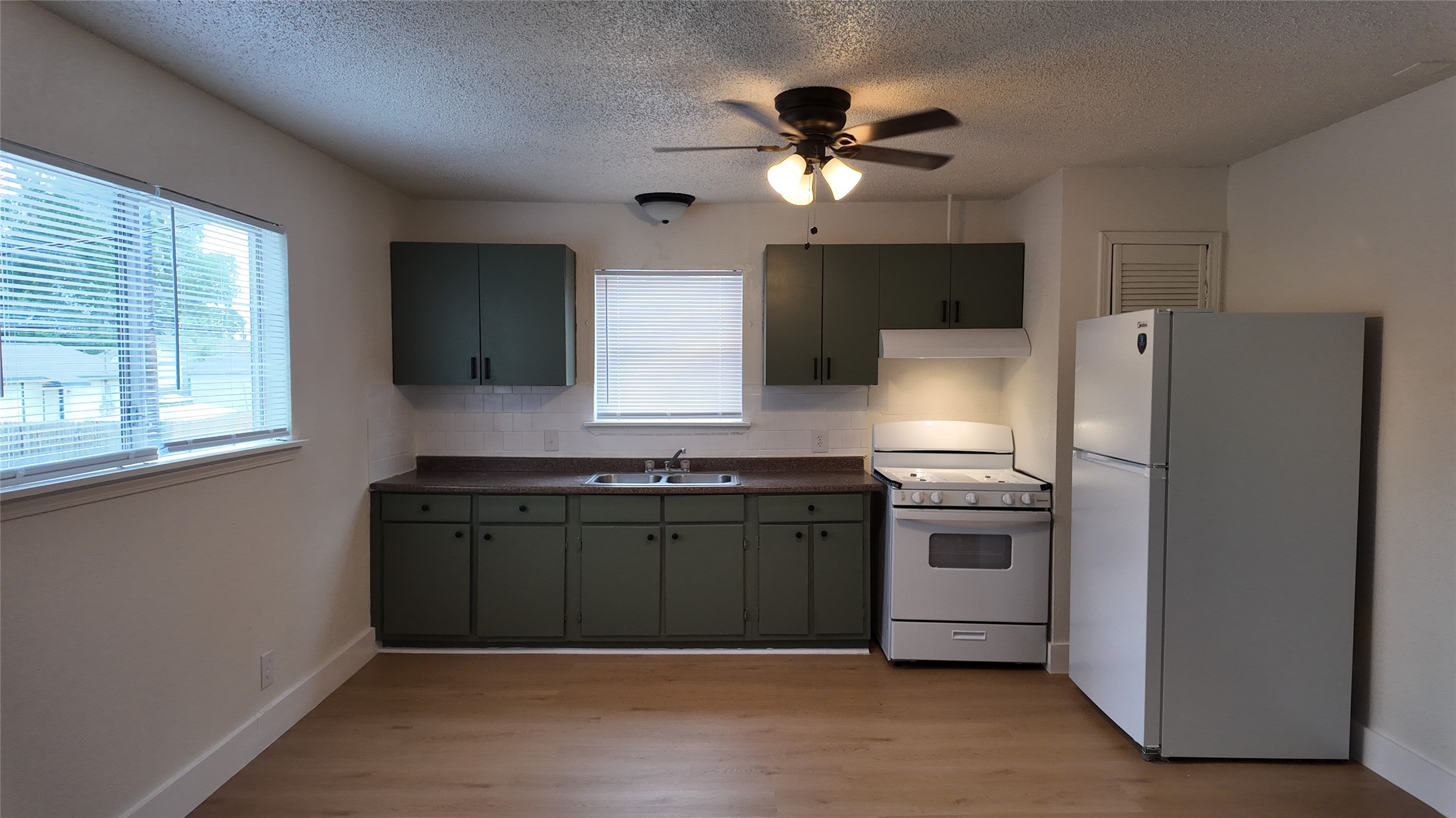 1510 Odd Fellow Street, Unit 21 Conroe, TX 77301 - Photo 1 of 7 a kitchen with stainless steel appliances granite countertop a refrigerator a stove top oven a sink and dishwasher