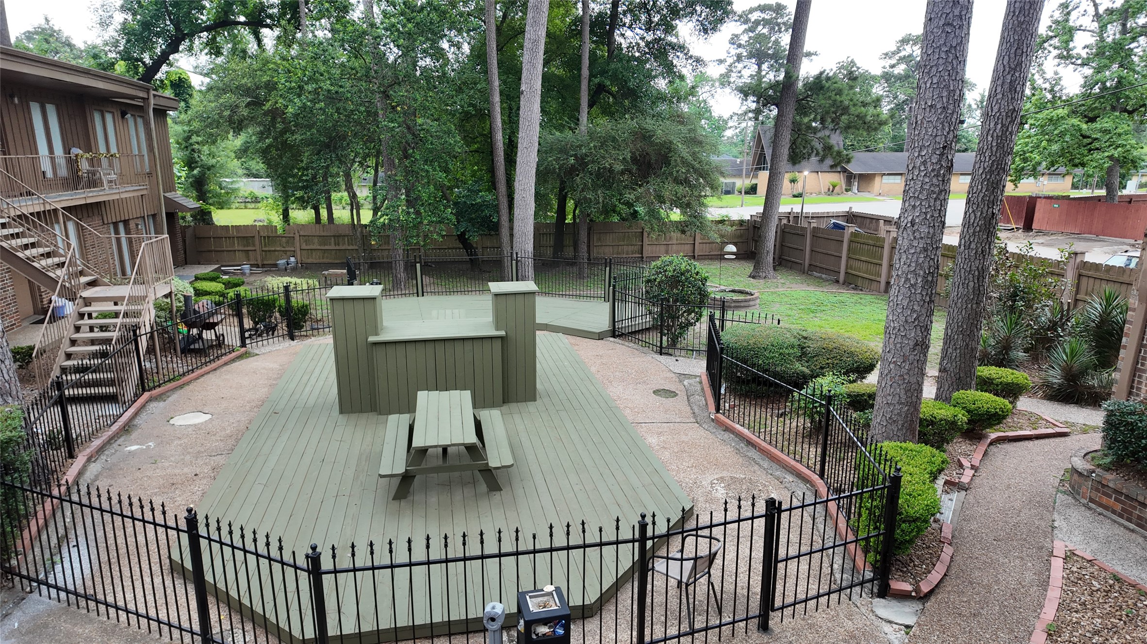 1510 Odd Fellow Street, Unit 21 Conroe, TX 77301 - Photo 7 of 7 a view of a patio with couches table and chairs and potted plants