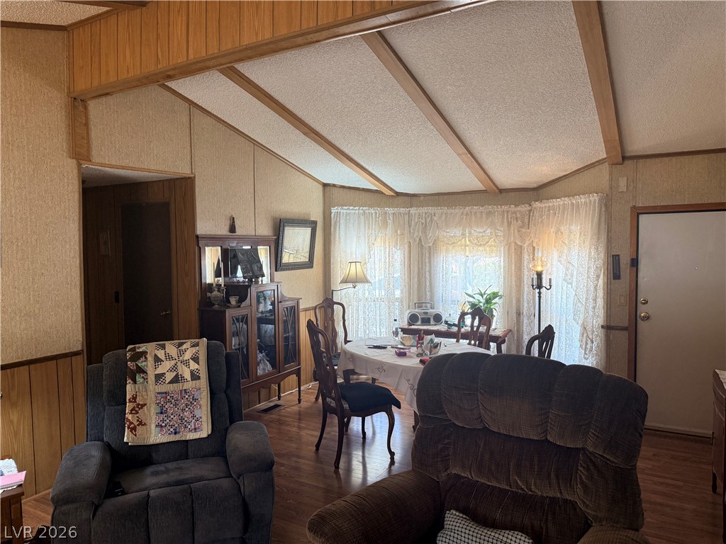 1391 West Dyer Road Pahrump, NV 89048 - Photo 39 of 50 A comfortable dining area with wood paneling and vaulted ceilings, perfect for cozy gatherings.
