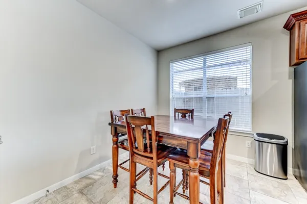 a view of a dining room with furniture and a window