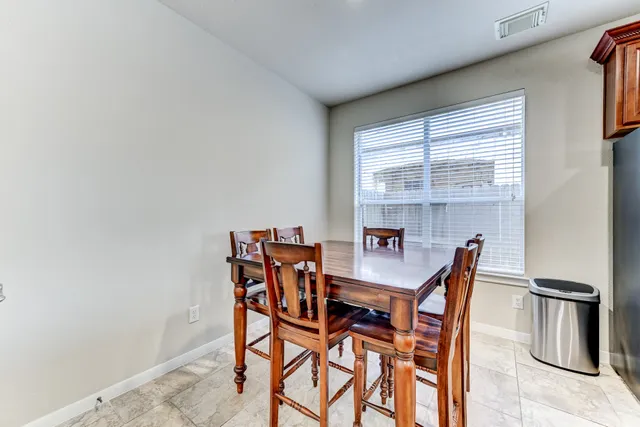 a view of a dining room with furniture and a window