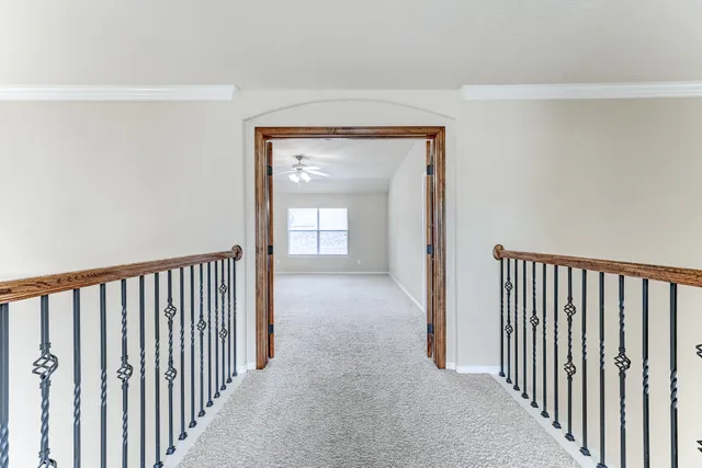 a view of a hallway with wooden floor and a hallway