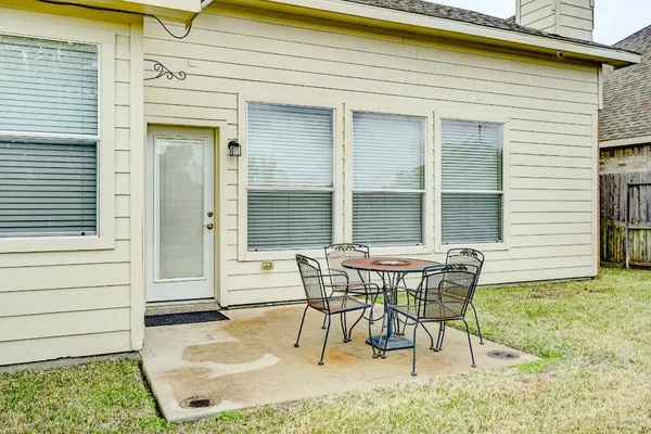 a view of a house with backyard and sitting area