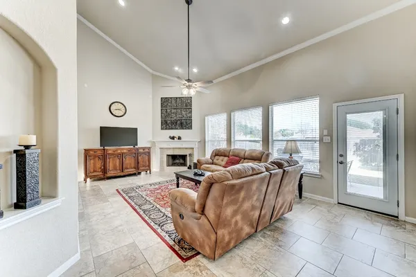a living room with furniture large window and a flat screen tv