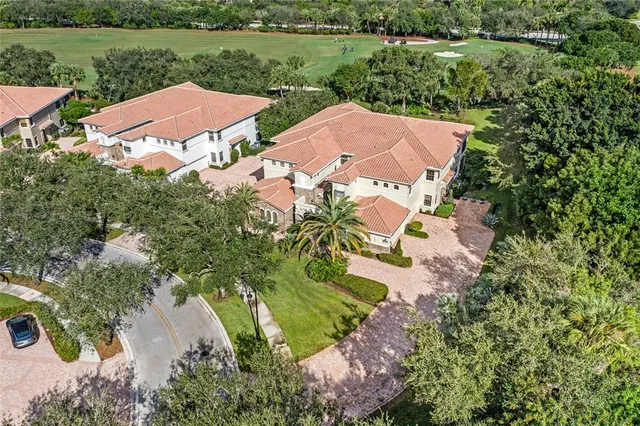 an aerial view of a house with outdoor space and a lake view