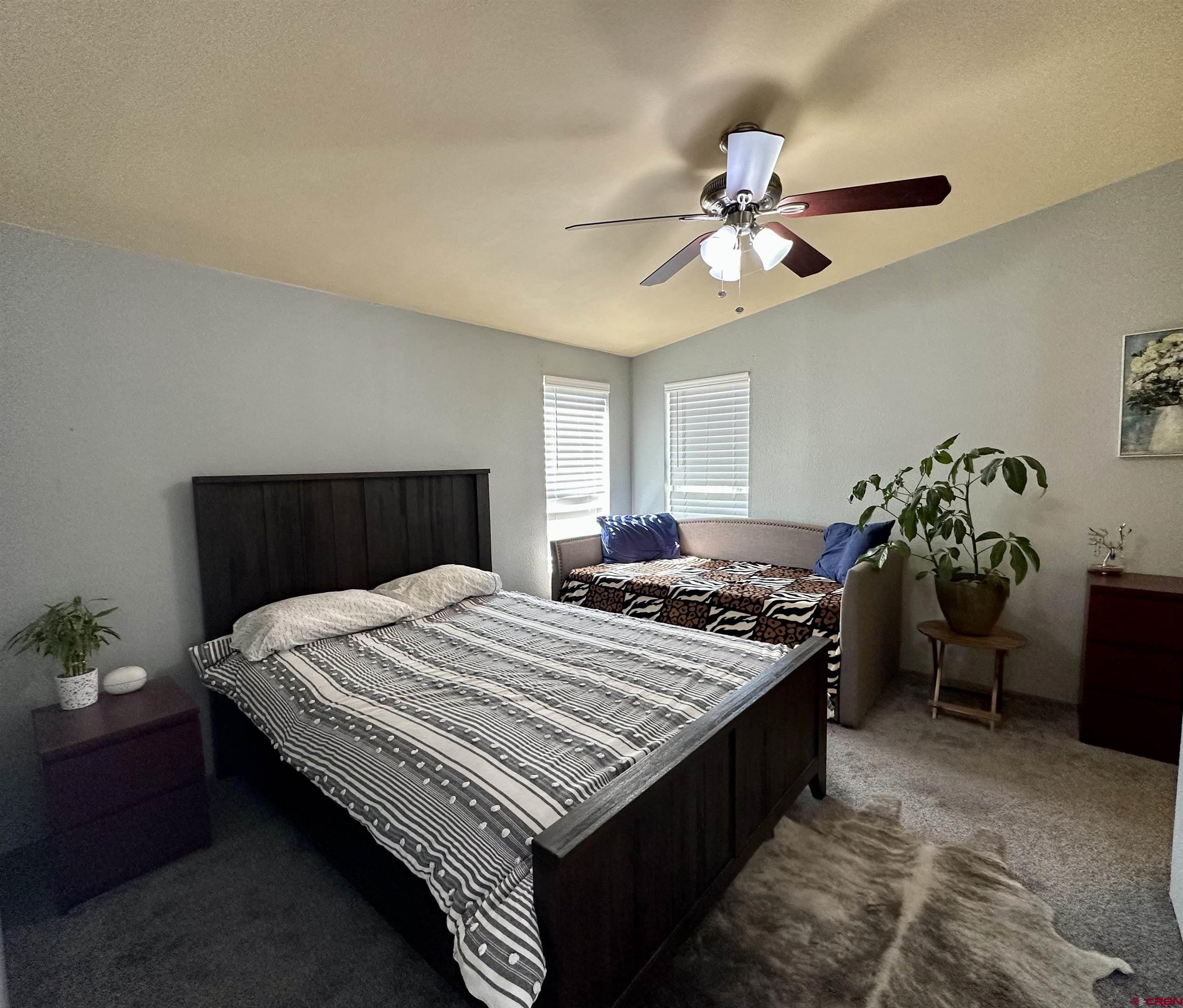 6000 County Road 203, Unit 55 Durango, CO 81301 - Photo 13 of 33 a bed room with a bed and a chandelier