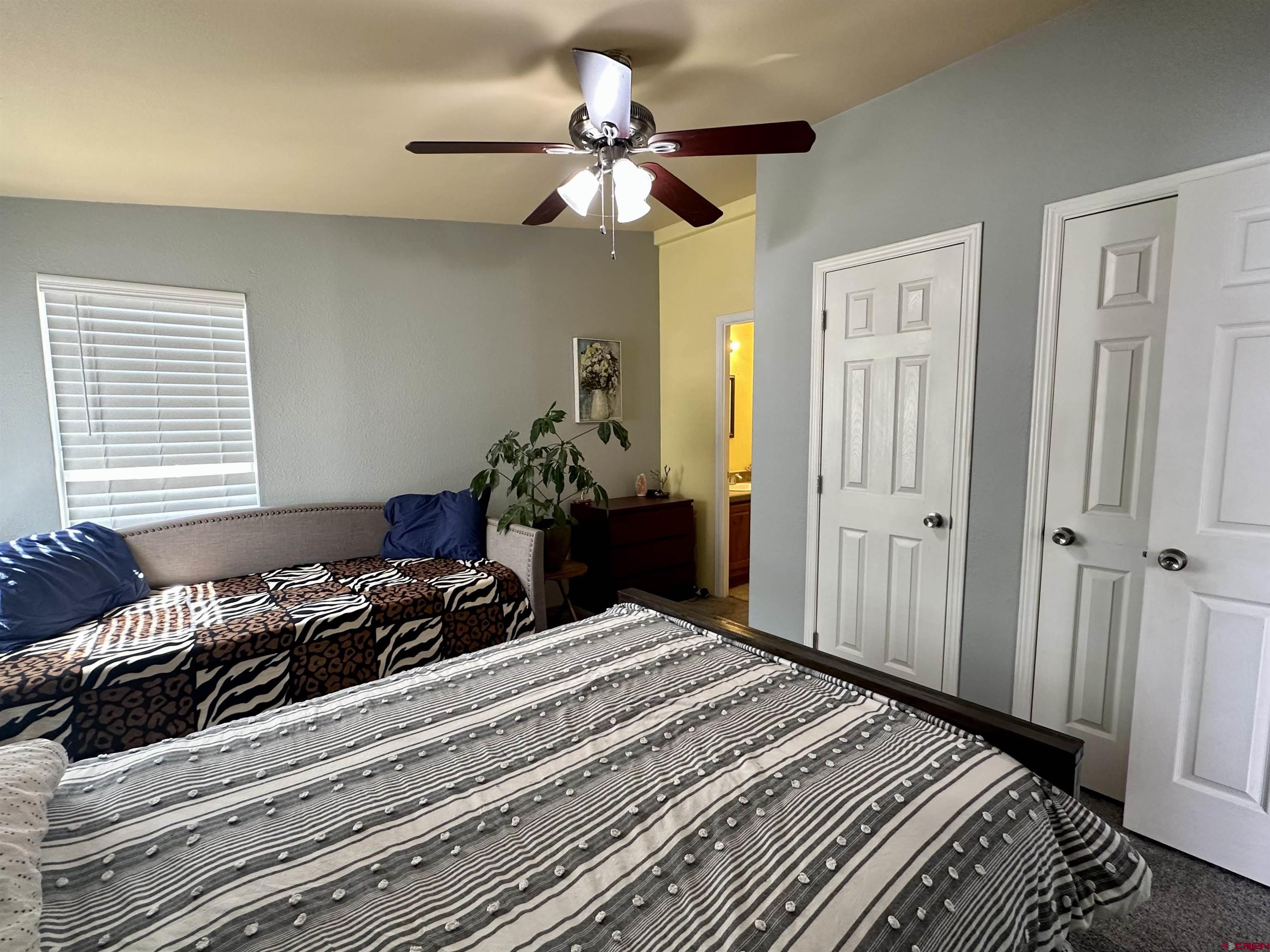6000 County Road 203, Unit 55 Durango, CO 81301 - Photo 14 of 33 a bedroom with a bed and ceiling fan