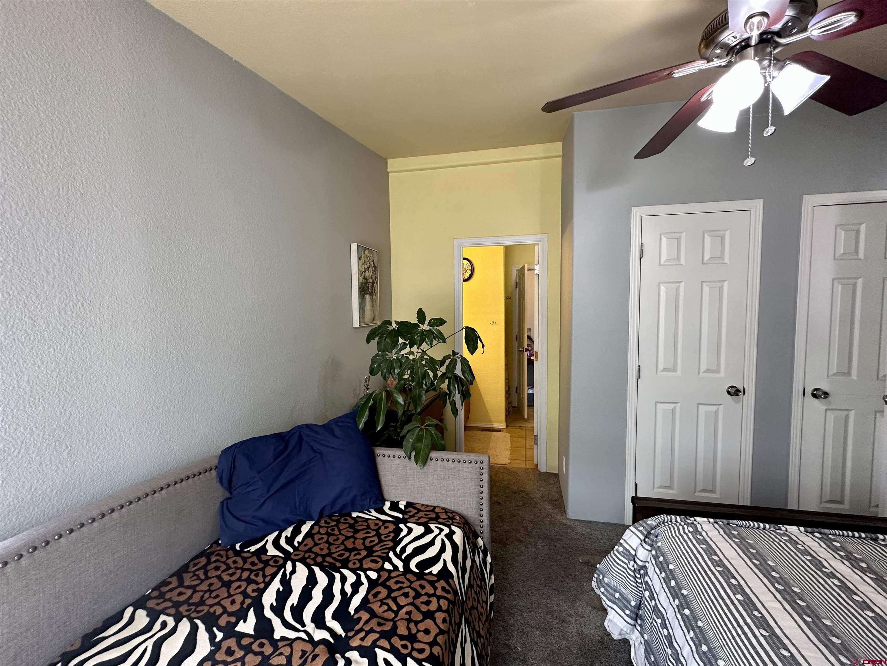 6000 County Road 203, Unit 55 Durango, CO 81301 - Photo 15 of 33 a view of a bedroom with a bed and wooden floor