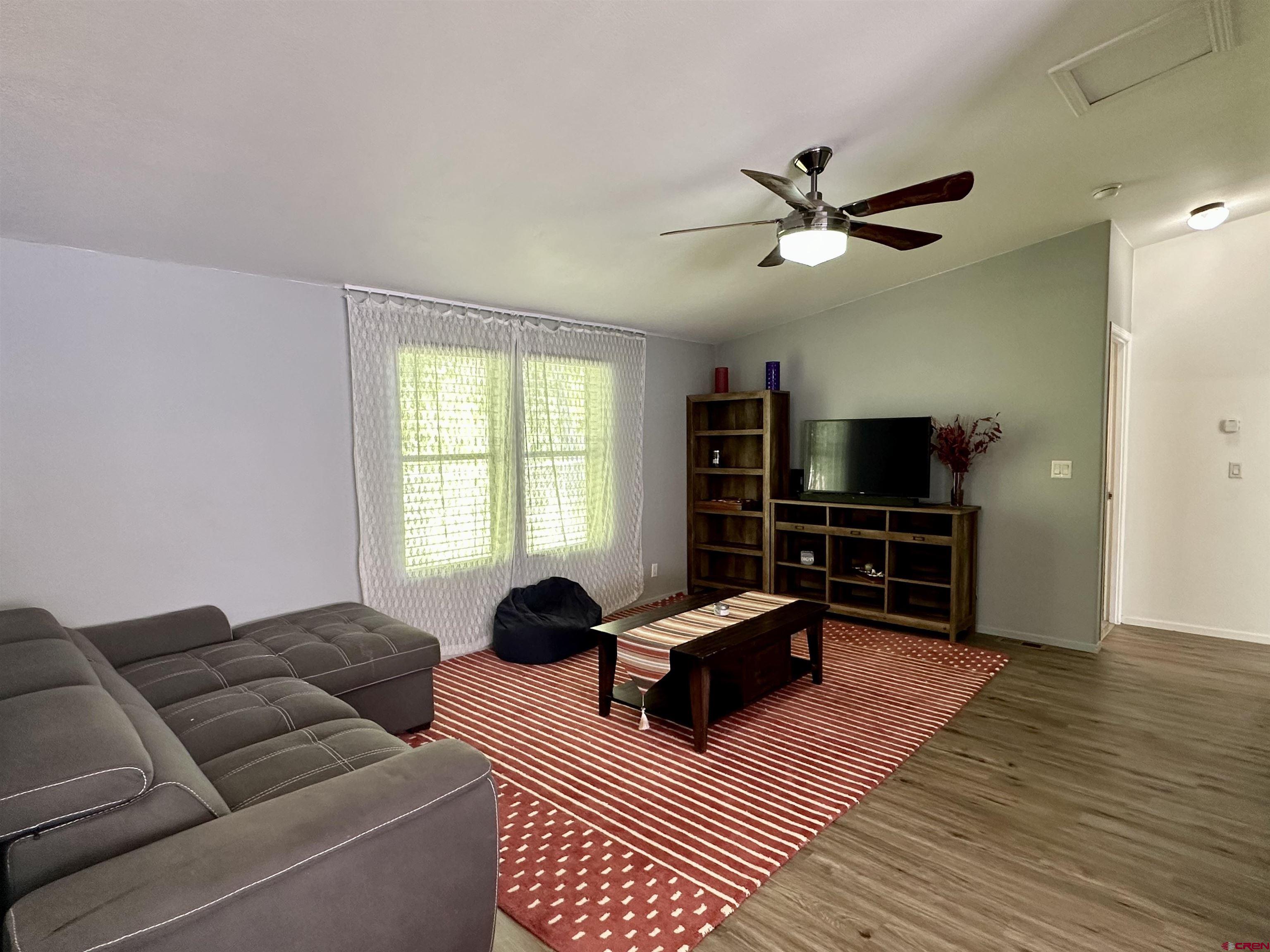 6000 County Road 203, Unit 55 Durango, CO 81301 - Photo 18 of 33 a living room with furniture ceiling fan and a window