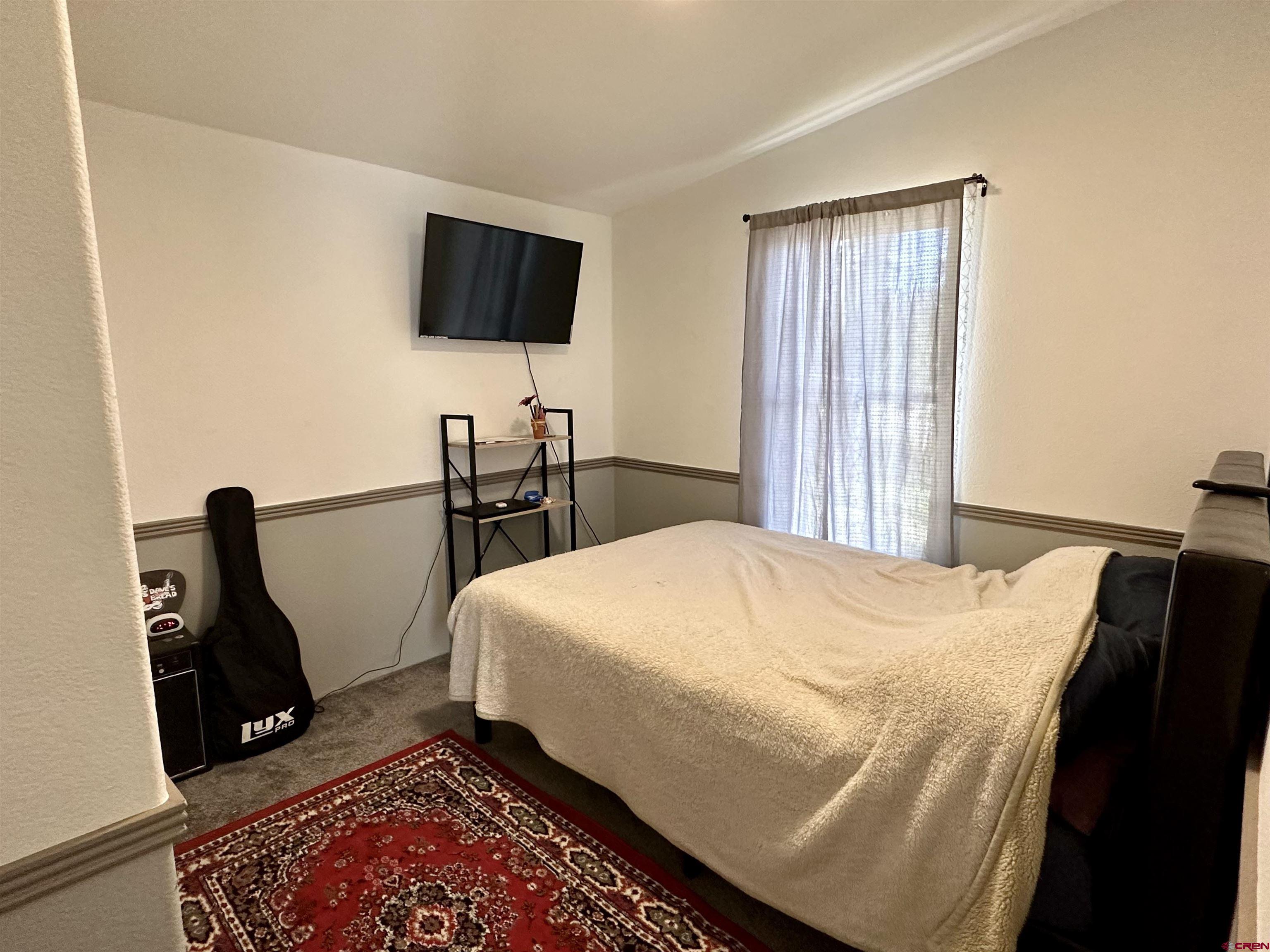 6000 County Road 203, Unit 55 Durango, CO 81301 - Photo 19 of 33 a bedroom with a bed a flat screen tv and furniture