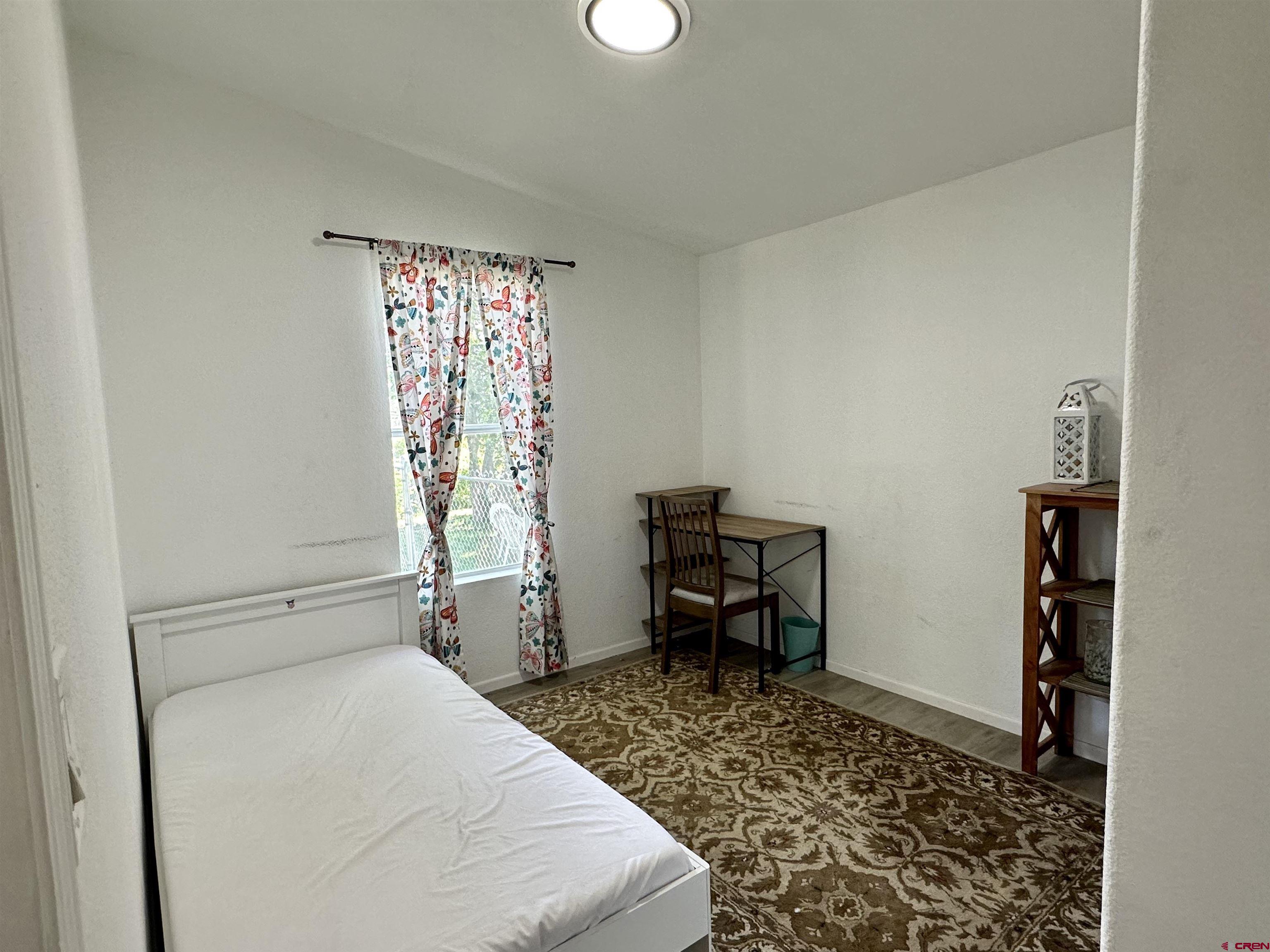 6000 County Road 203, Unit 55 Durango, CO 81301 - Photo 22 of 33 a bedroom with a bed and a table in it