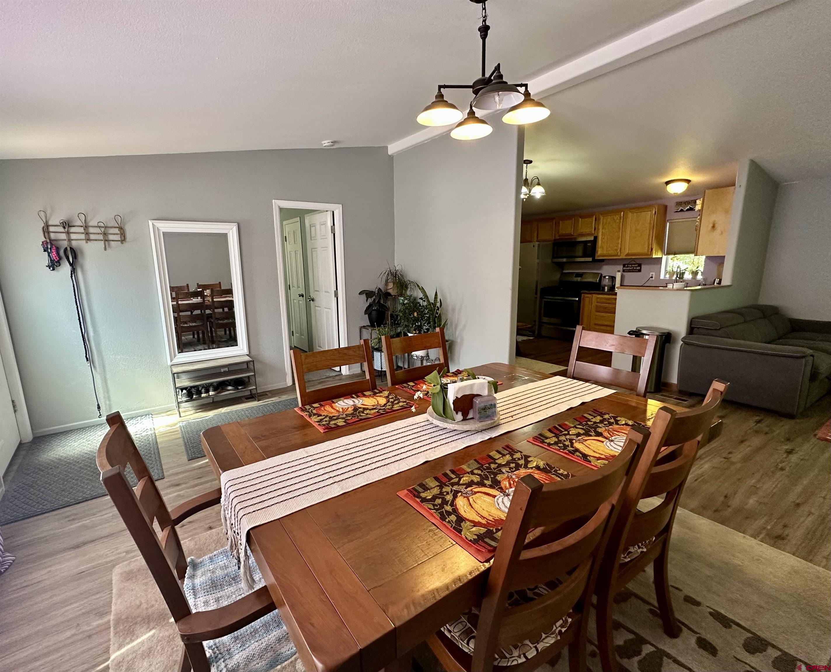 6000 County Road 203, Unit 55 Durango, CO 81301 - Photo 4 of 33 a dining room with furniture a chandelier and wooden floor