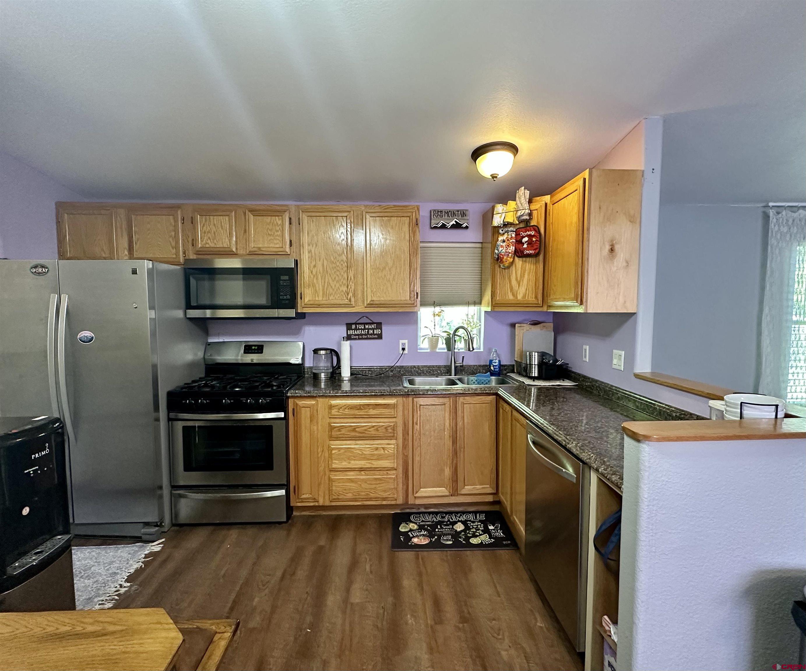 6000 County Road 203, Unit 55 Durango, CO 81301 - Photo 7 of 33 a kitchen with stainless steel appliances granite countertop a sink a stove and a refrigerator