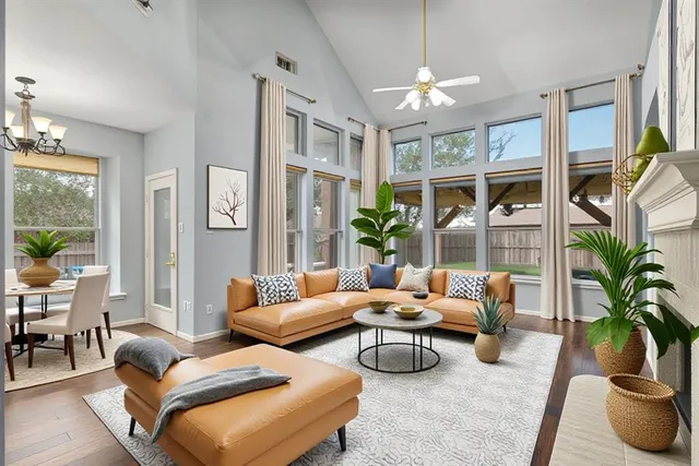 a living room with furniture and a chandelier
