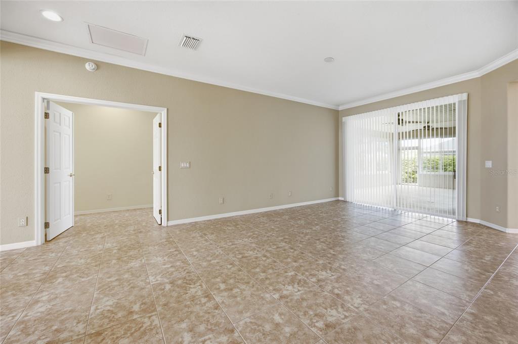 9029 Southeast 130th Loop Summerfield, FL 34491 - Photo 13 of 55 a view of an empty room with glass door