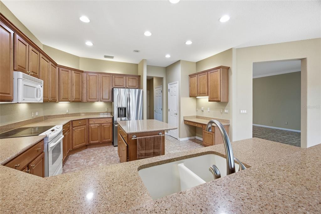 9029 Southeast 130th Loop Summerfield, FL 34491 - Photo 15 of 55 a kitchen with granite countertop a sink and a stove top oven